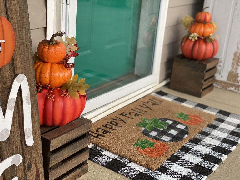 Fall front porch with stacked pumpkins