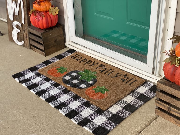 https://www.southernadoornmentsdecor.com/wp-content/uploads/2020/09/Layered-front-door-mat-with-black-and-white-buffalo-plaid-fall-porch-decor-by-southern-a-door-nments-768x576.jpg