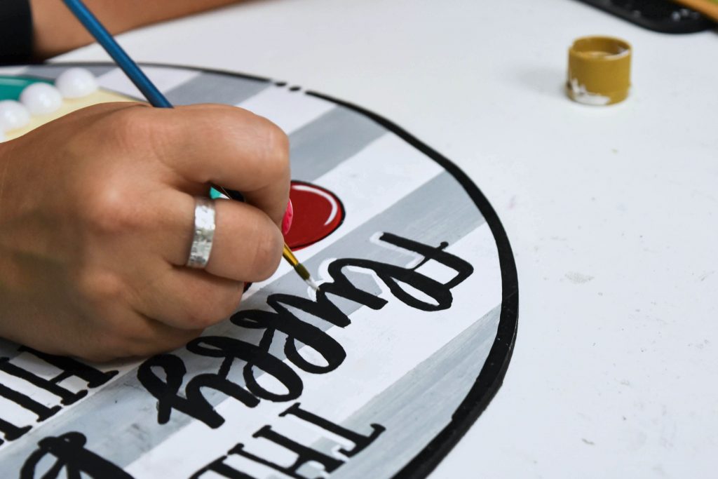 Tamara Bennett Painting the lettering she created with Canva.