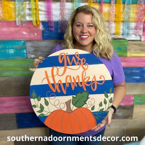 Tamara holding the painted Give Thanks on Shiplap Door Hanger