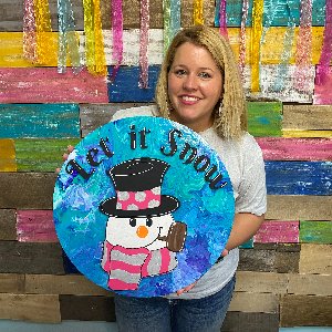 Tamara holding the Snowman with Scarf door hanger she had just painted