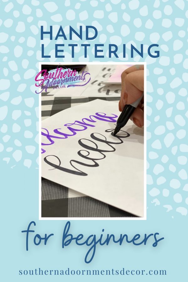 pinterest image that has someone hand lettering with the text "hand lettering for beginnners"