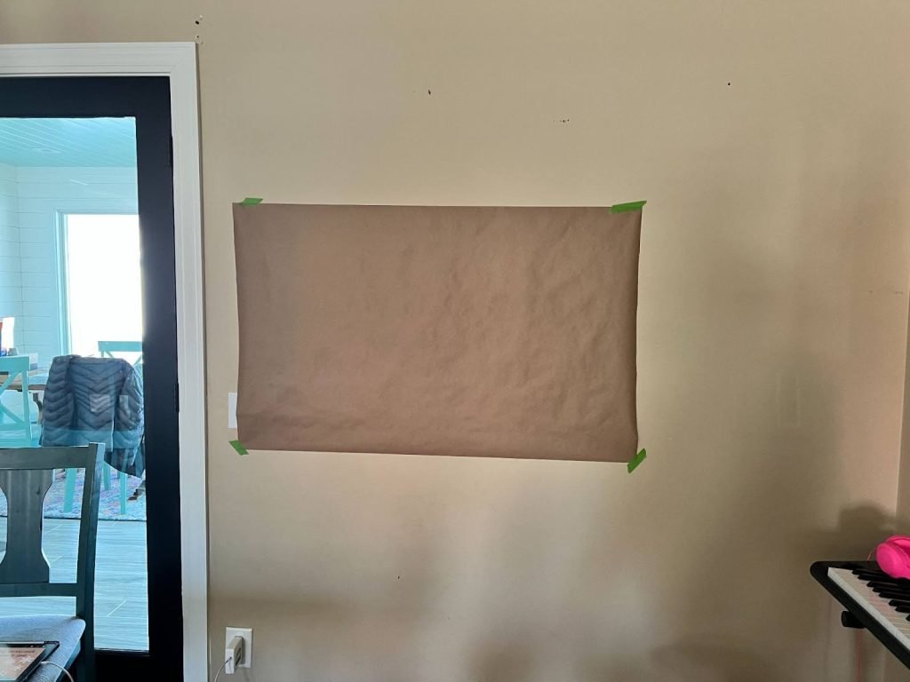 piece of brown paper tapped to the wall