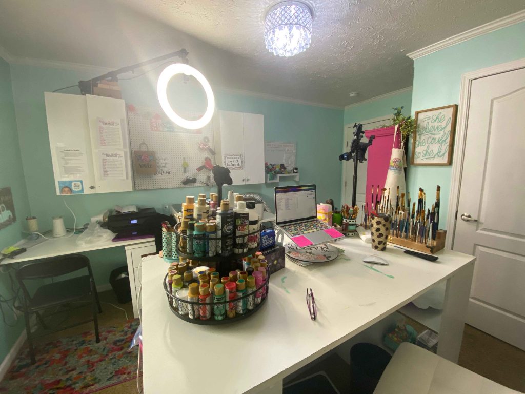 craft room overview with supplies on the table and ring light overhead
