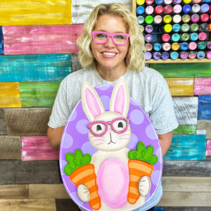 Tamara with finished painting of glasses bunny