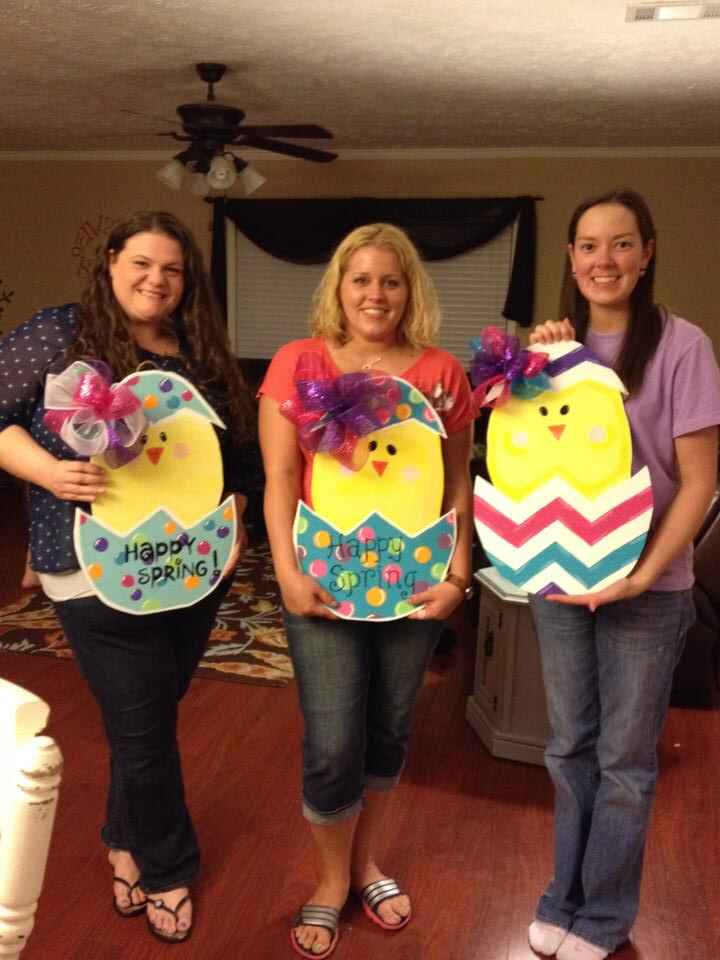 Lauren, Tamara and a friend holding their easter door hangers from the early crafting days