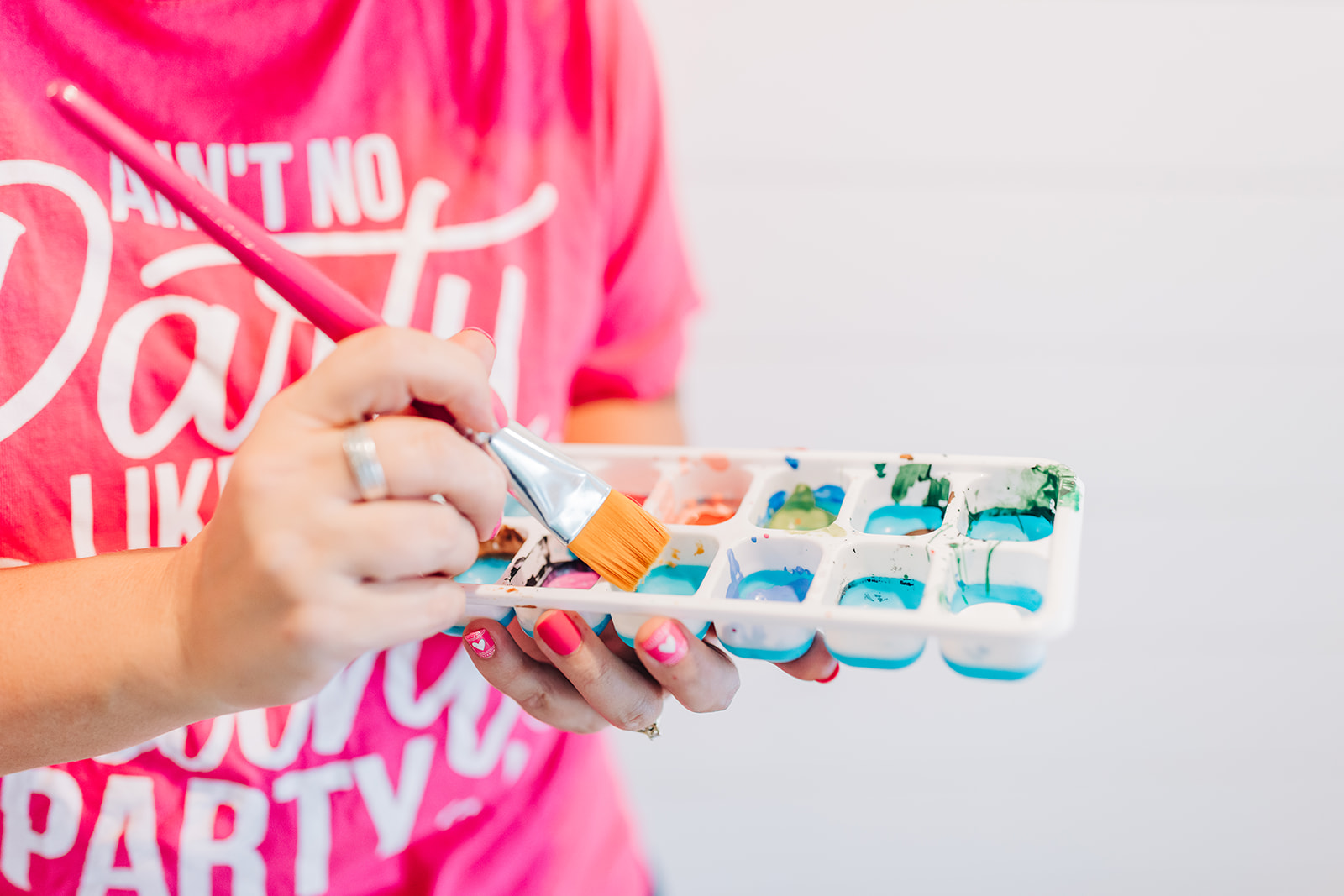 Tamara holding an ice cube tray with paints in each