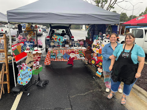 PC Sister Laura showing off her door hanger booth at a craft fair!